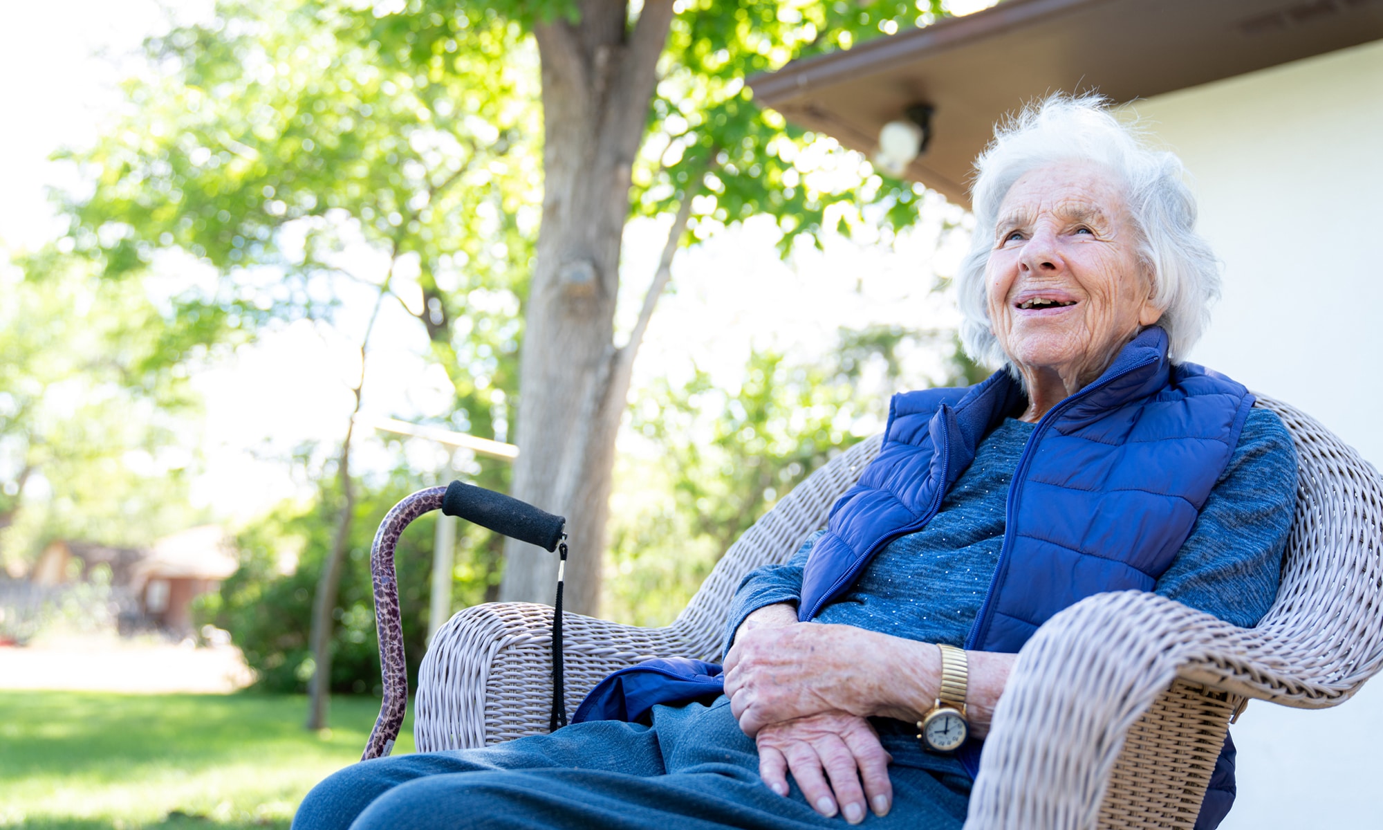 Elderly woman sitting outside in chair